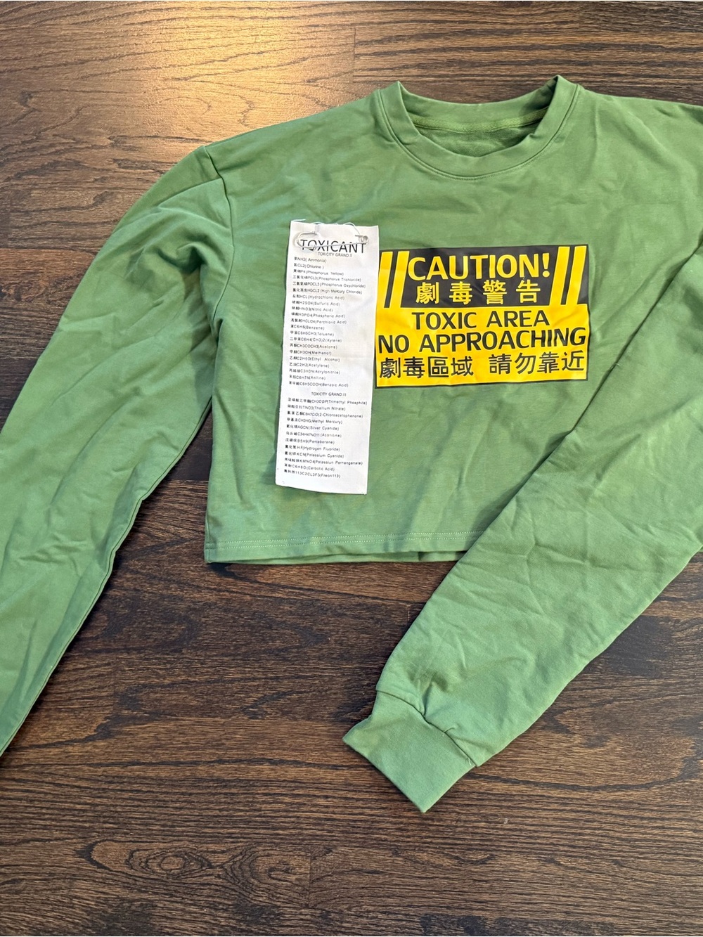 Green Cropped Sweatshirt with Yellow 'Caution Toxic Area' Graphic